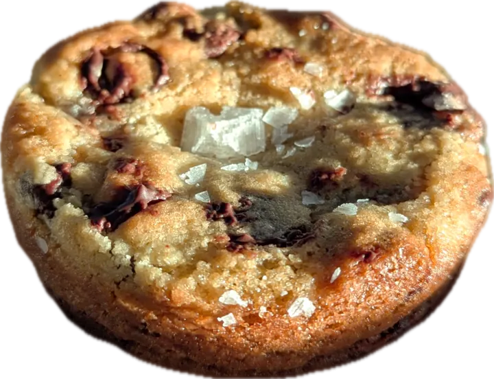 A thick chocolate chip cookie topped with flaky sea salt